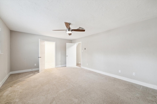 empty room featuring visible vents, baseboards, a textured ceiling, carpet flooring, and ceiling fan