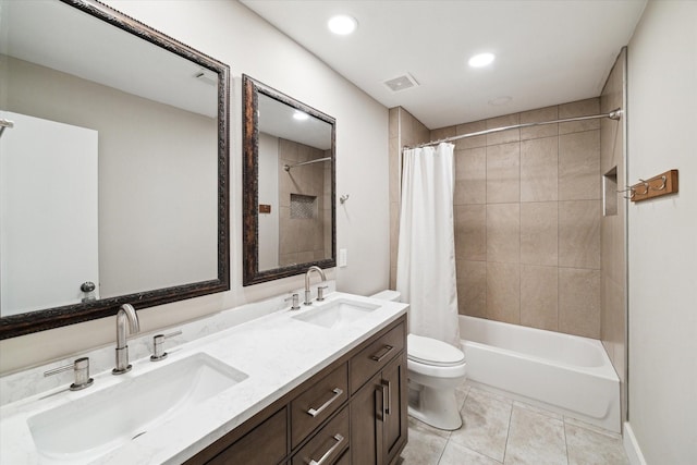 bathroom featuring tile patterned floors, visible vents, a sink, and toilet