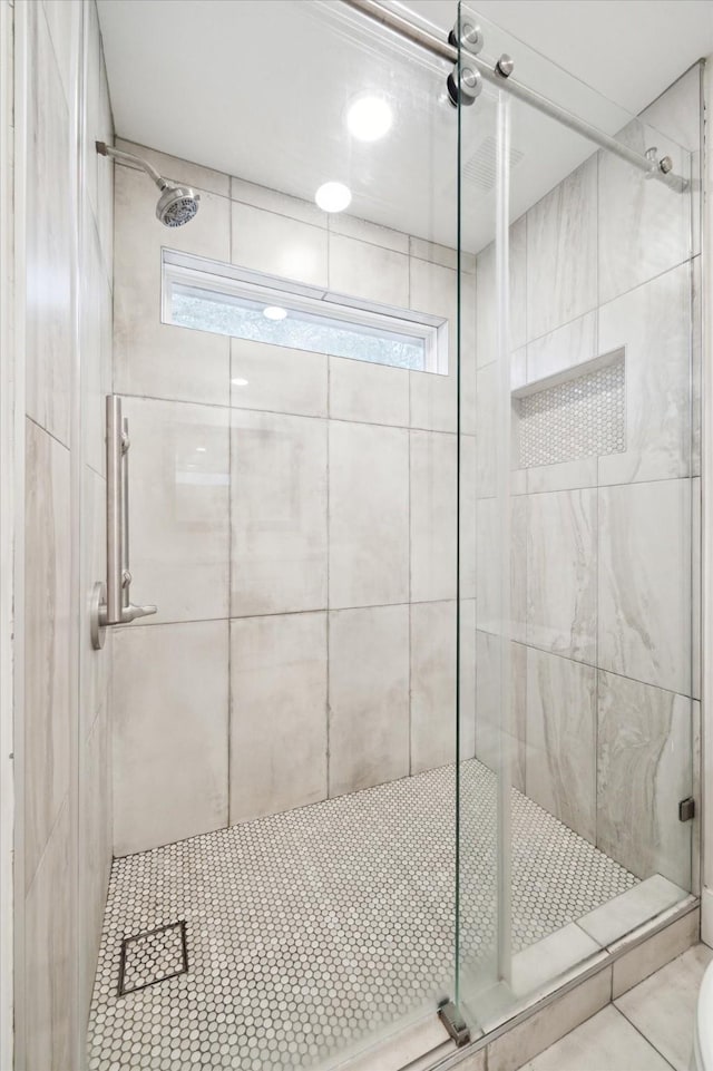 bathroom featuring tile patterned floors and a shower stall