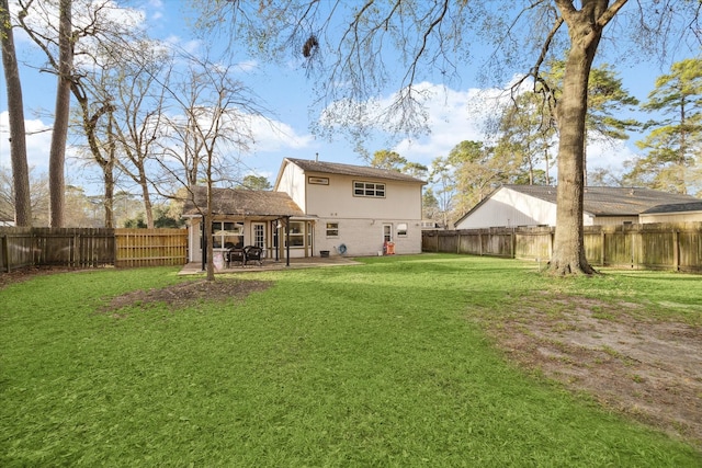 back of house featuring a lawn, a patio, and a fenced backyard