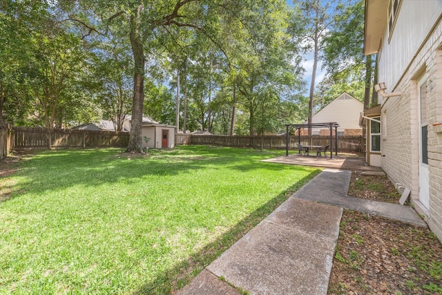 view of yard with a fenced backyard, an outbuilding, and a storage shed