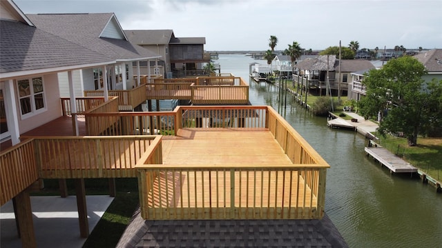 wooden terrace with a residential view, a water view, and stairway
