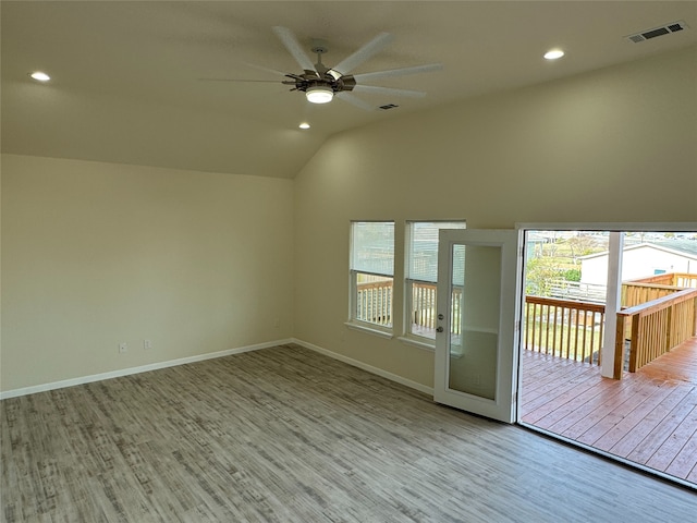 unfurnished room with recessed lighting, lofted ceiling, wood finished floors, visible vents, and a ceiling fan