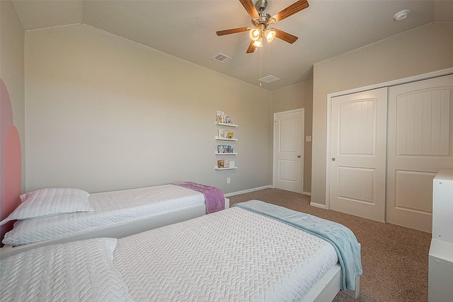 carpeted bedroom with vaulted ceiling, baseboards, visible vents, a closet, and ceiling fan