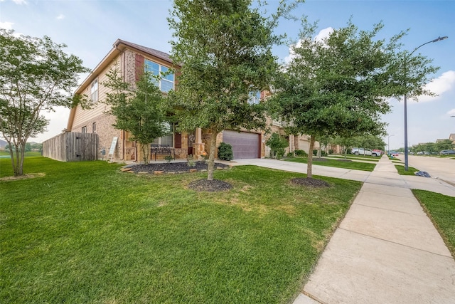 view of property hidden behind natural elements with concrete driveway, a front lawn, brick siding, and a garage