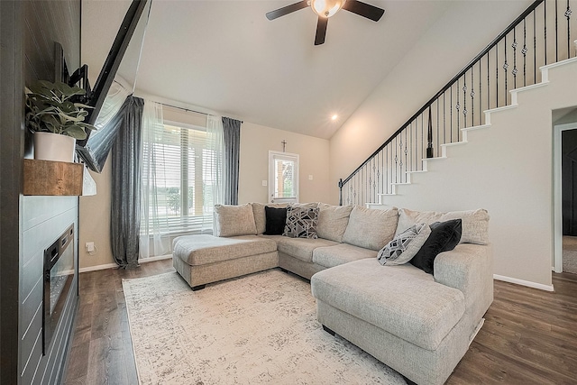 living room with baseboards, a ceiling fan, dark wood-style floors, and stairs