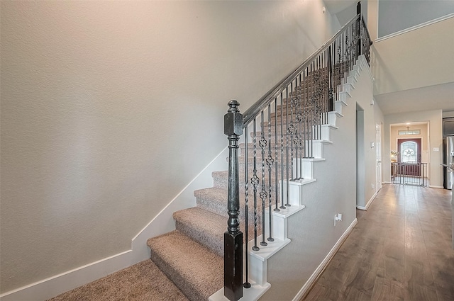 stairs with baseboards and wood finished floors