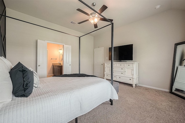 carpeted bedroom with vaulted ceiling, baseboards, ensuite bathroom, and ceiling fan