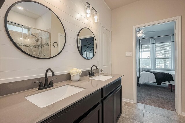 ensuite bathroom with plenty of natural light, a stall shower, and a sink