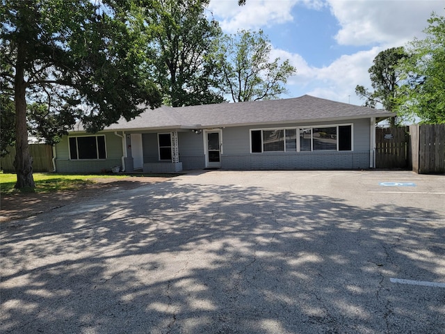 single story home featuring fence and brick siding