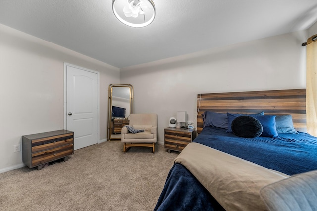 bedroom featuring carpet floors and baseboards