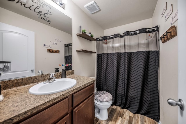 full bathroom featuring wood finished floors, visible vents, curtained shower, and vanity