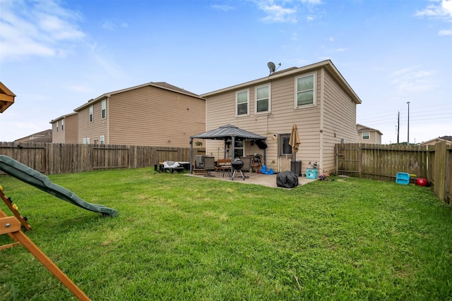 back of property with a patio, a fenced backyard, a lawn, and a gazebo