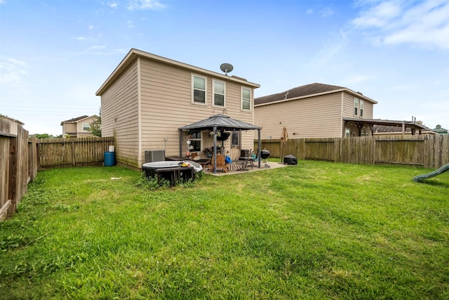 rear view of property with a yard, a patio, a gazebo, and a fenced backyard