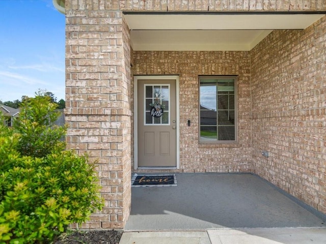 entrance to property with brick siding