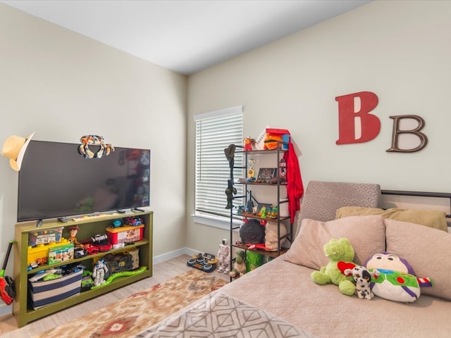 bedroom with wood finished floors and baseboards