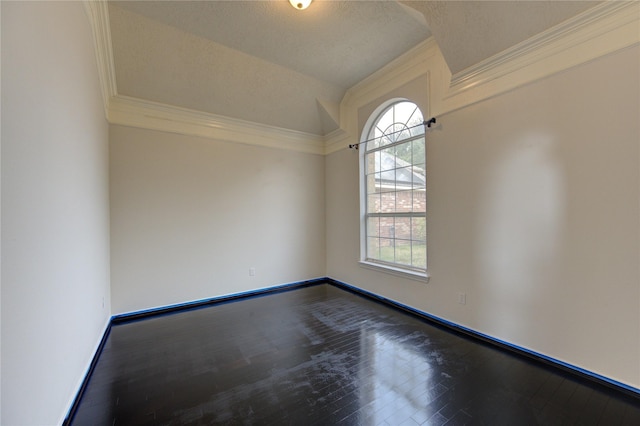 spare room with baseboards, a textured ceiling, crown molding, and dark wood-style floors