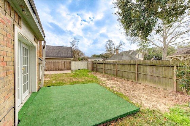 view of yard with a fenced backyard