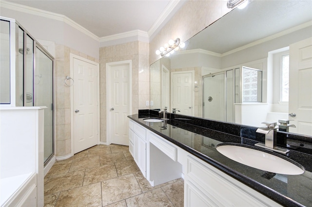 full bath featuring a shower stall, ornamental molding, a sink, and double vanity