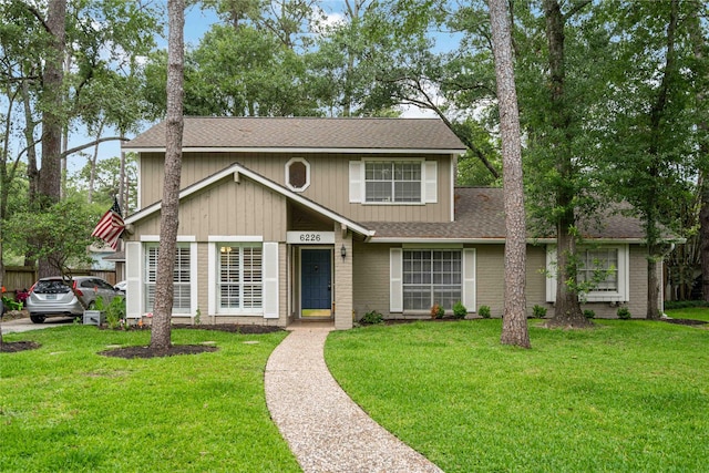 6226 Allentown Dr, Spring, TX 77389 - view of front of property featuring brick siding, roof with shingles, and a front lawn