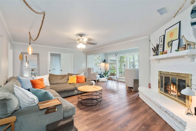 6226 Allentown Dr, Spring, TX 77389 - living room with ornamental molding, a brick fireplace, visible vents, and wood finished floors