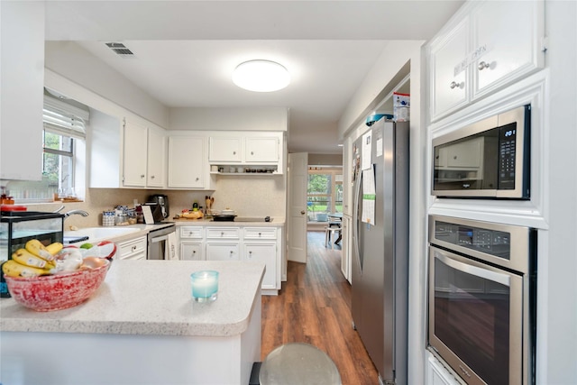 6226 Allentown Dr, Spring, TX 77389 - kitchen with white cabinetry, a wealth of natural light, and stainless steel appliances