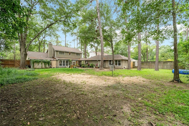 6226 Allentown Dr, Spring, TX 77389 - rear view of house with a chimney, a yard, and a fenced backyard