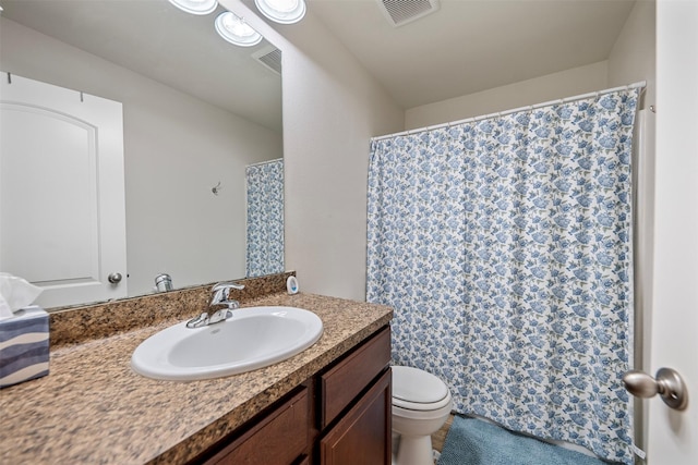 bathroom featuring toilet, visible vents, and vanity