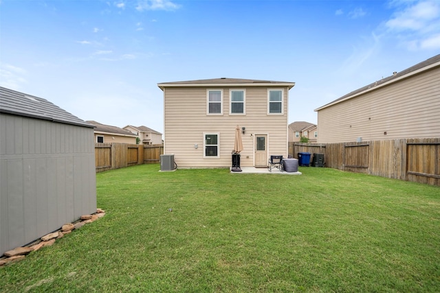 rear view of house featuring central air condition unit, a lawn, a fenced backyard, and a patio area