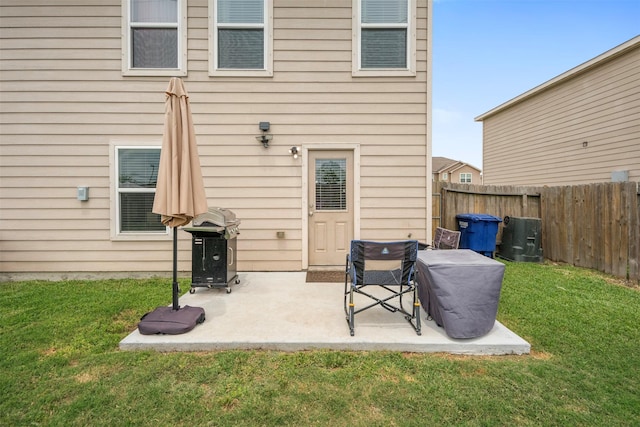 back of property featuring a patio, fence, and a yard