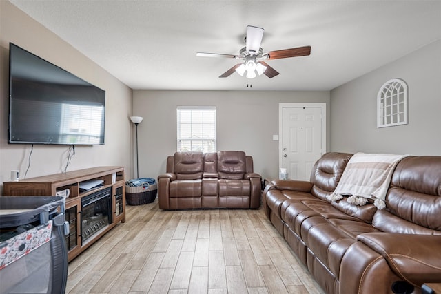 living area featuring a ceiling fan and light wood-style flooring