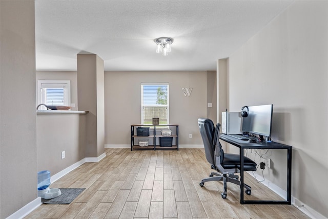 office area featuring baseboards and wood finished floors