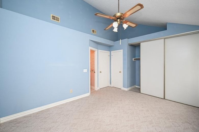 unfurnished bedroom featuring vaulted ceiling, baseboards, visible vents, a closet, and carpet floors