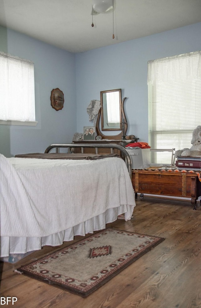 bedroom with a ceiling fan and wood finished floors