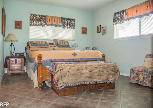 bedroom featuring baseboards and tile patterned floors