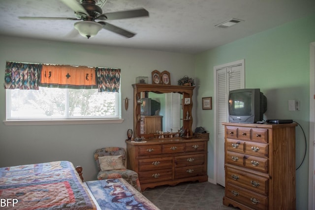 bedroom featuring tile patterned flooring, a ceiling fan, and visible vents