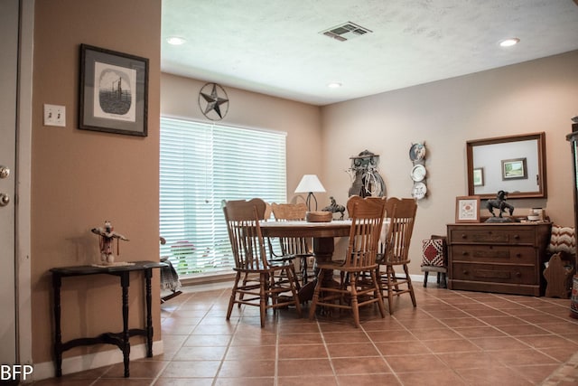tiled dining space with plenty of natural light, recessed lighting, baseboards, and visible vents