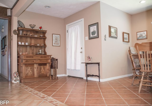 interior space featuring light tile patterned flooring, baseboards, and recessed lighting