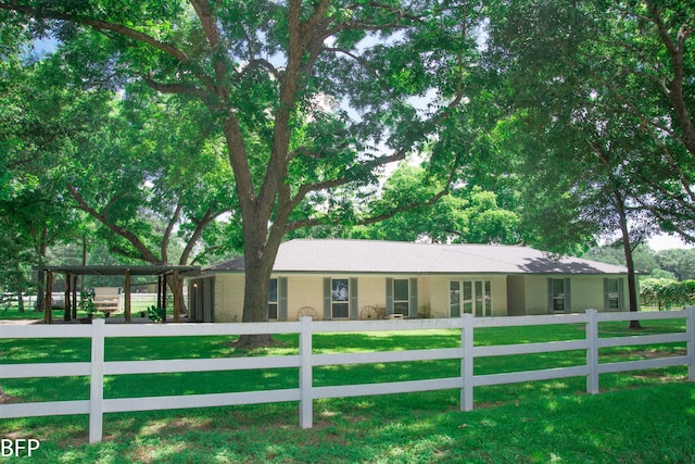 ranch-style house featuring a fenced front yard, a front lawn, and brick siding