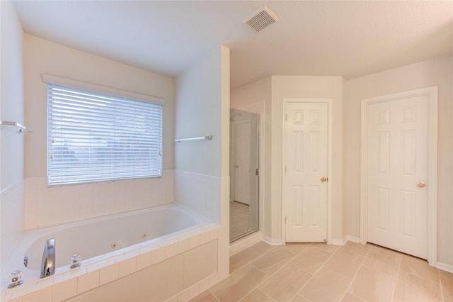 bathroom with plenty of natural light, visible vents, a shower stall, and a jetted tub