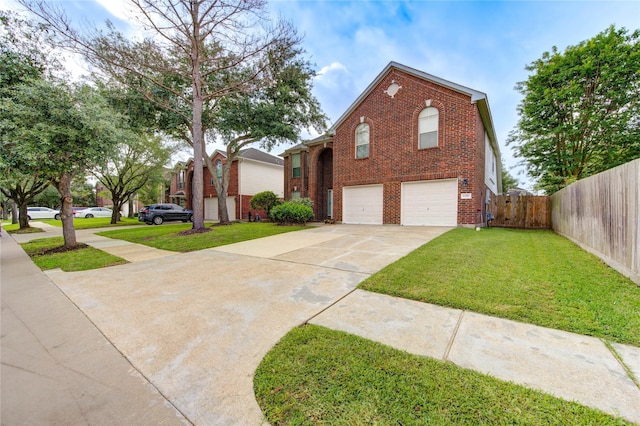 traditional-style house featuring fence, a front yard, brick siding, concrete driveway, and an attached garage