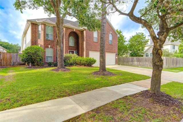 view of front facade with fence, brick siding, a garage, a front yard, and concrete driveway
