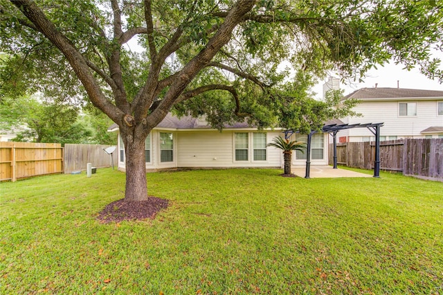 back of property with a fenced backyard, a pergola, a yard, and a patio