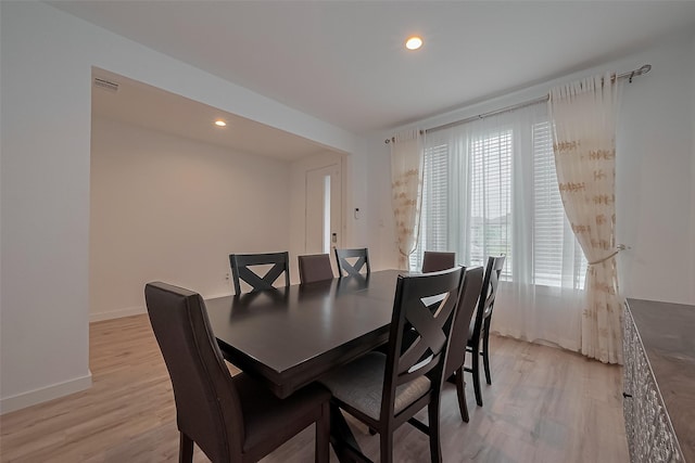 dining room featuring light wood finished floors, baseboards, recessed lighting, and visible vents
