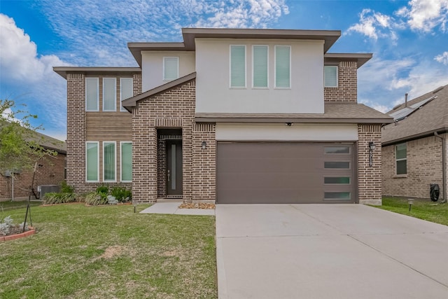 view of front of house featuring a front lawn, stucco siding, driveway, brick siding, and a garage