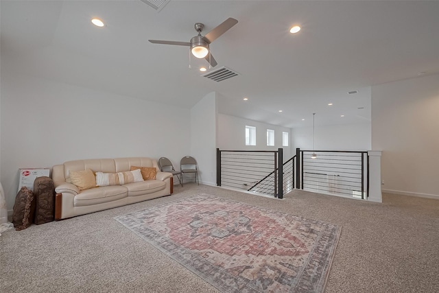 carpeted living area featuring baseboards, a ceiling fan, visible vents, and recessed lighting