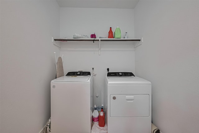 clothes washing area featuring washer and clothes dryer and laundry area