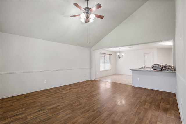 7218 Alava Dr, Magnolia, TX 77354 - unfurnished living room featuring ceiling fan, wood finished floors, a chandelier, a sink, and high vaulted ceiling