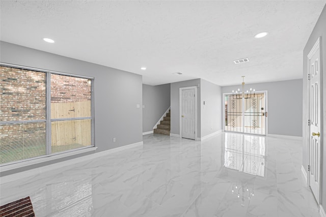 unfurnished living room with an inviting chandelier, visible vents, marble finish floor, stairway, and recessed lighting