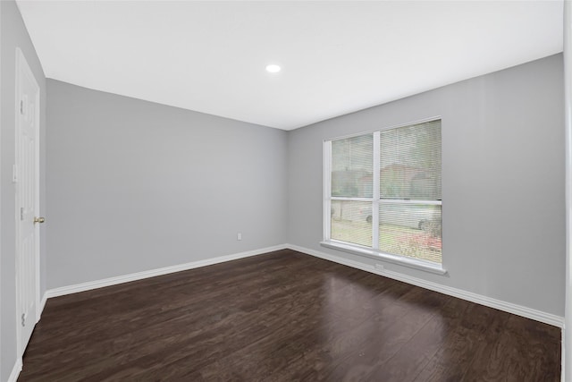 unfurnished room with baseboards, recessed lighting, and dark wood-type flooring